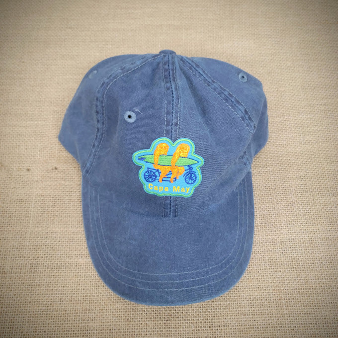 A blue hat with a patch of two sloths on a tandem on the front.