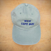 A green hat with 'West Cape May' embroidered on the front.
