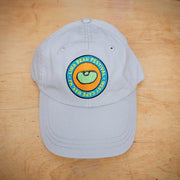 A khaki, classic hat with a lima bean patch on the front.