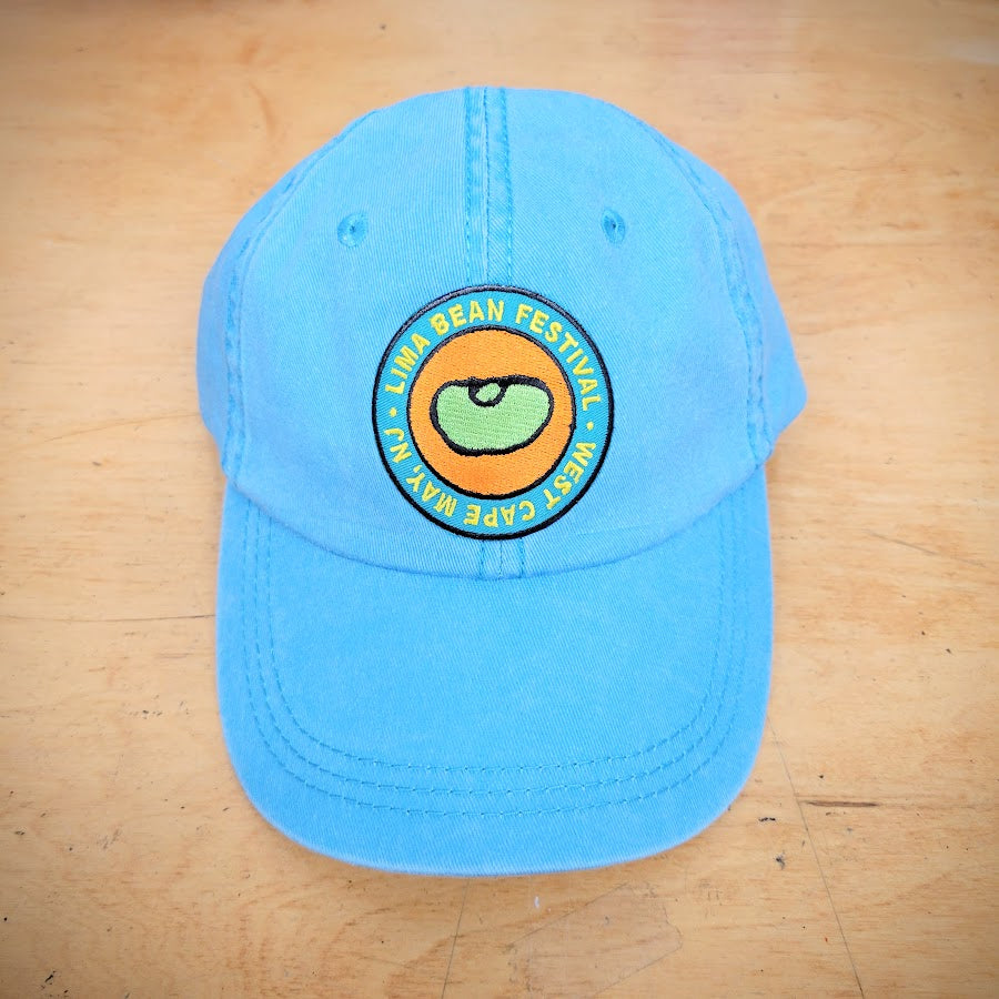 A blue, classic hat with a lima bean patch on the front.