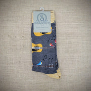 A pair of grey socks with birds and acoustic guitars on them.