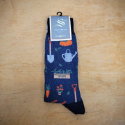 A pair of navy socks with gardening tools on them.