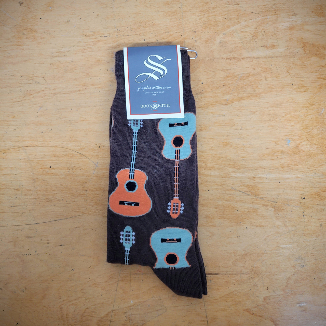 Brown, men's socks with acoustic guitars on them.