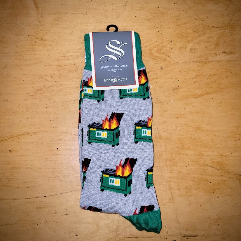 A pair of green and grey socks with dumpster fires on them.