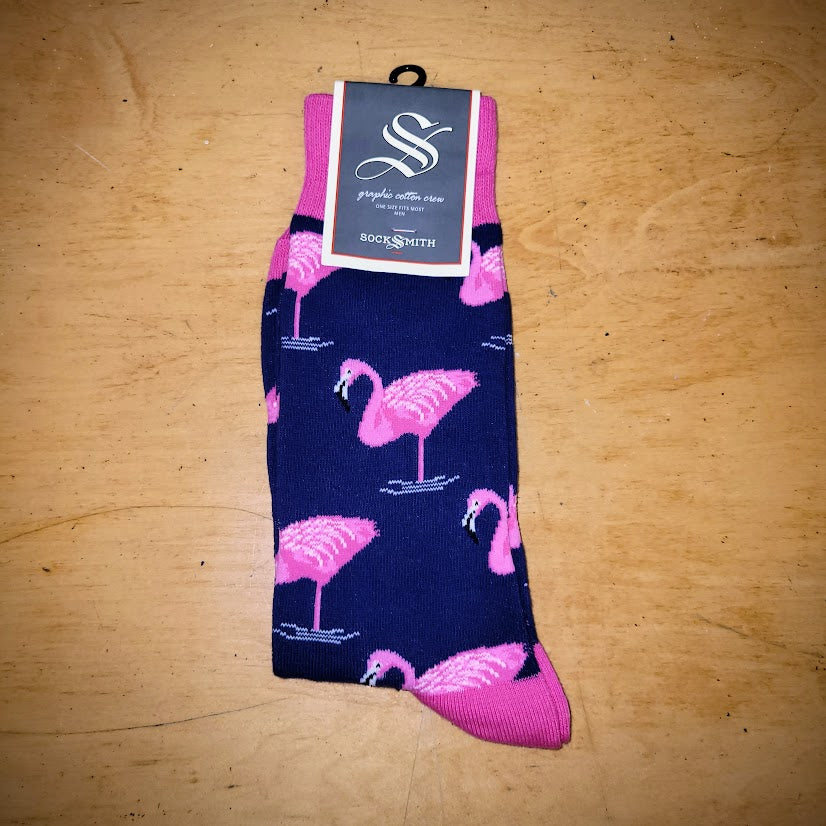A pair of navy and pink socks with flamingos on them.