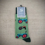 A green pair of socks with tractors on them.