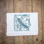 White, four sack tea towel featuring the 'Veggies' design in dark green ink.