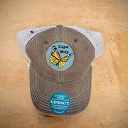 Brown & khaki, trucker hat with a 'Cape May Monarch' patch ironed on the front.