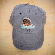 A brown, classic hat with a 'Horseshoe Crab' patch on the front.