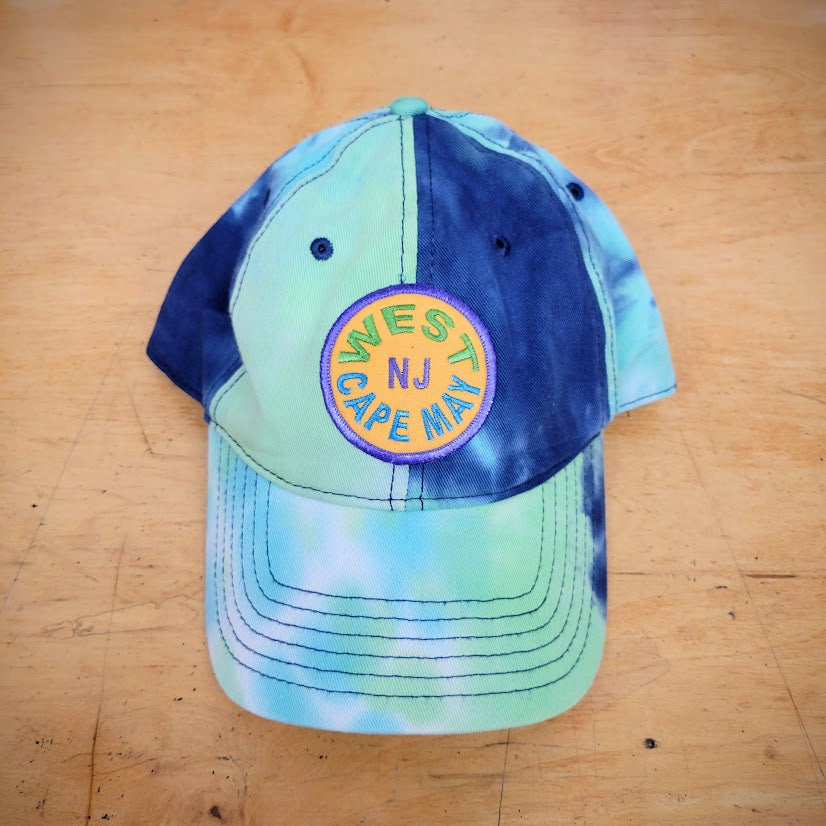 Blue and green tie-dye hat with a 'West Cape May' patch on it.