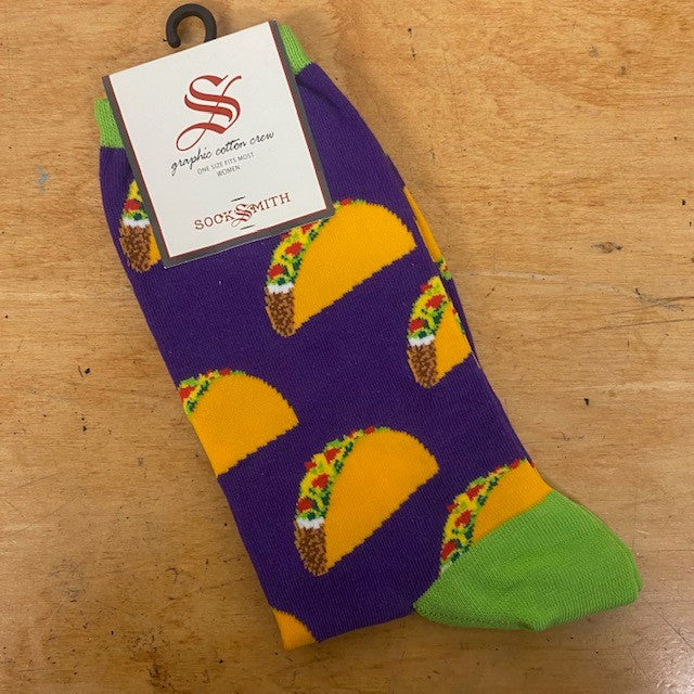 A pair of purple and green socks with tacos on them.