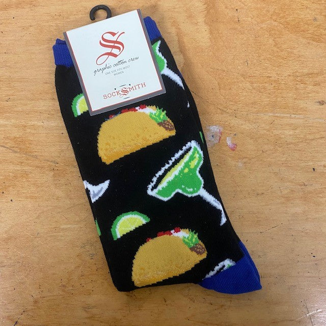 A pair of black and blue socks with tacos and margaritas on them.