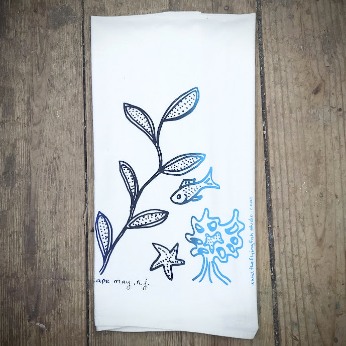 White, flour sack tea towel featuring the 'Sea Life' design in a dark to light blue gradient.