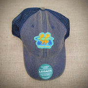 Adult trucker hat in navy, with a patch of two little sloths on the front, riding a tandem while holding a surf board.