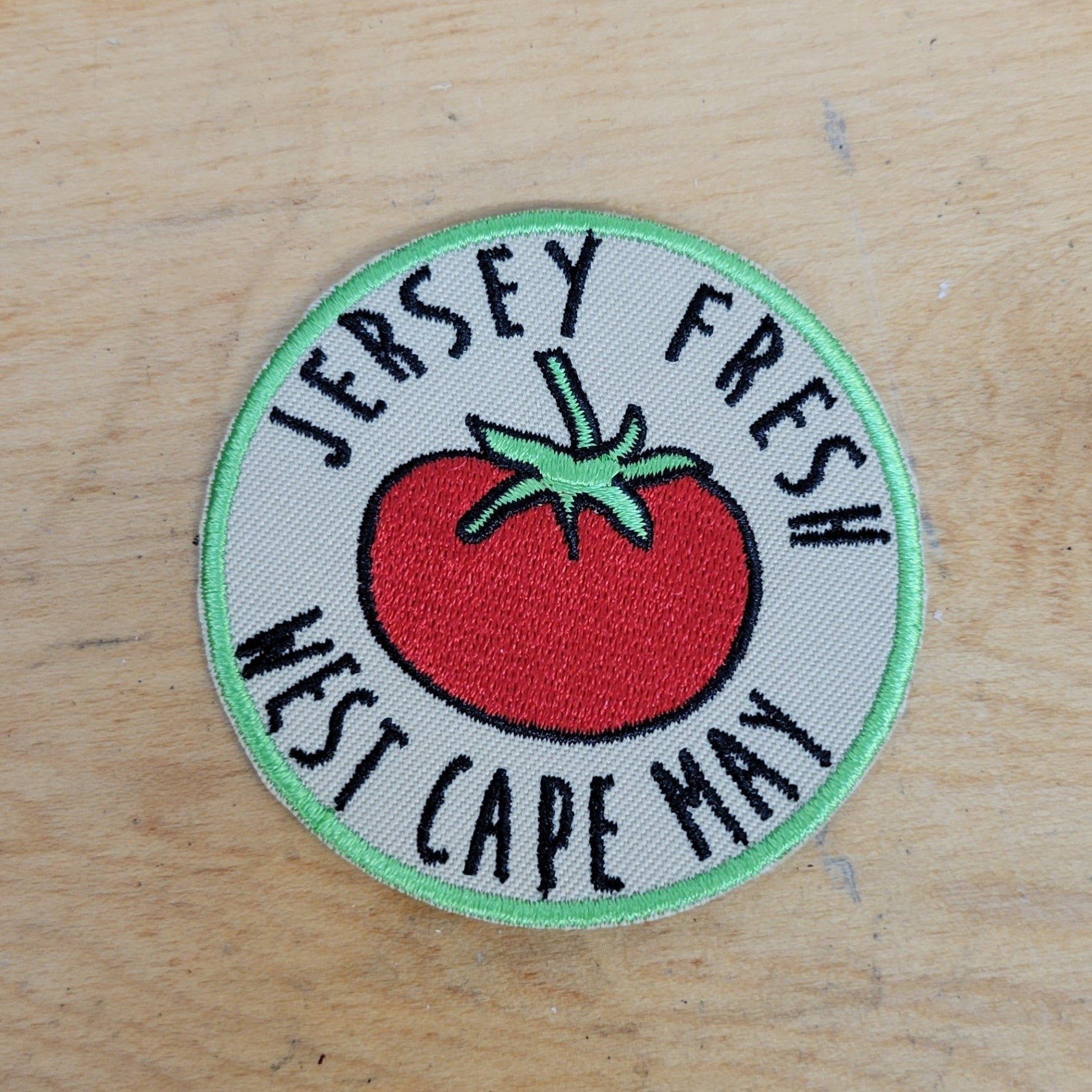 Green-rimmed, white patch that features a bright red tomato. Includes 'Jersey Fresh, West Cape May' on the front.