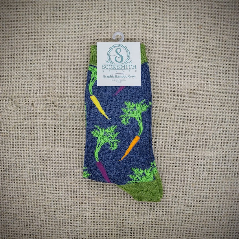 A blue and green pair of socks with carrots on them.