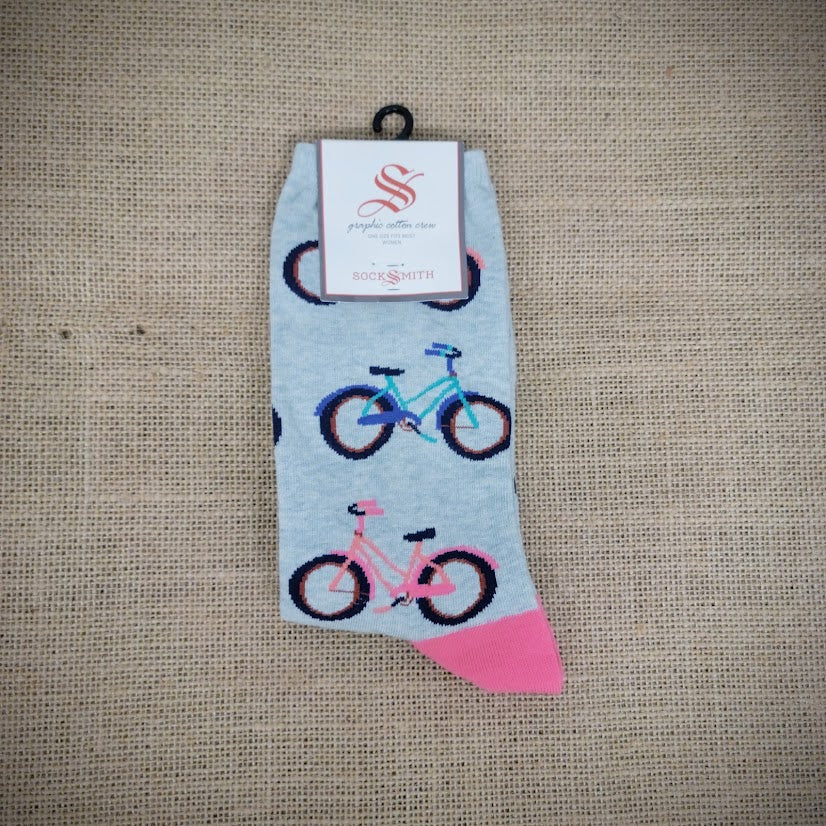 A mint and pink pair of socks with bikes on them.