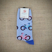 A blue pair of socks with bikes on them.