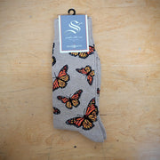A pair of brown socks with butterflies on them.