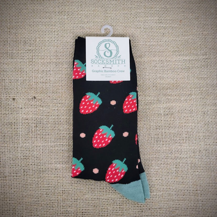 a pair of black socks with strawberries on them.