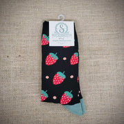 a pair of black socks with strawberries on them.