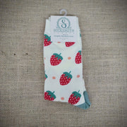 An ivory pair of socks with strawberries on them.