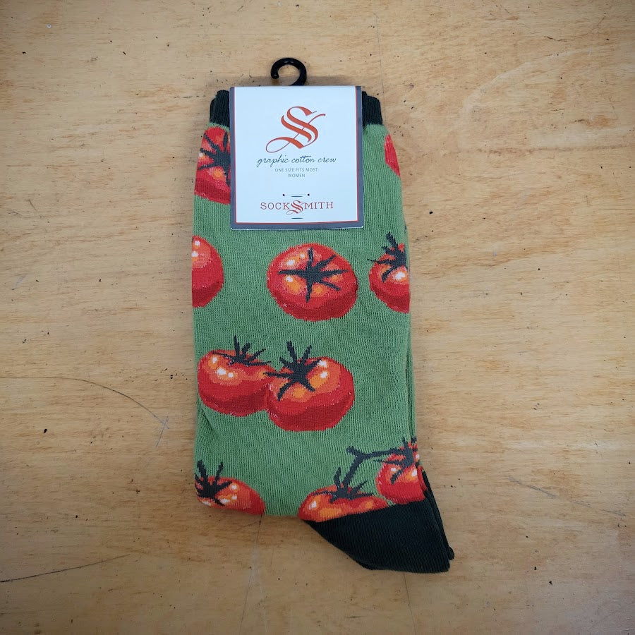 A green pair of socks with tomatoes on them.