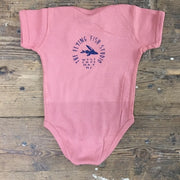 Mauve onesie featuring the 'Flying Fish' logo on the upper back in navy ink.