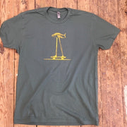 A green t-shirt featuring the 'Fish on a Skateboard' design on the front in gold ink.