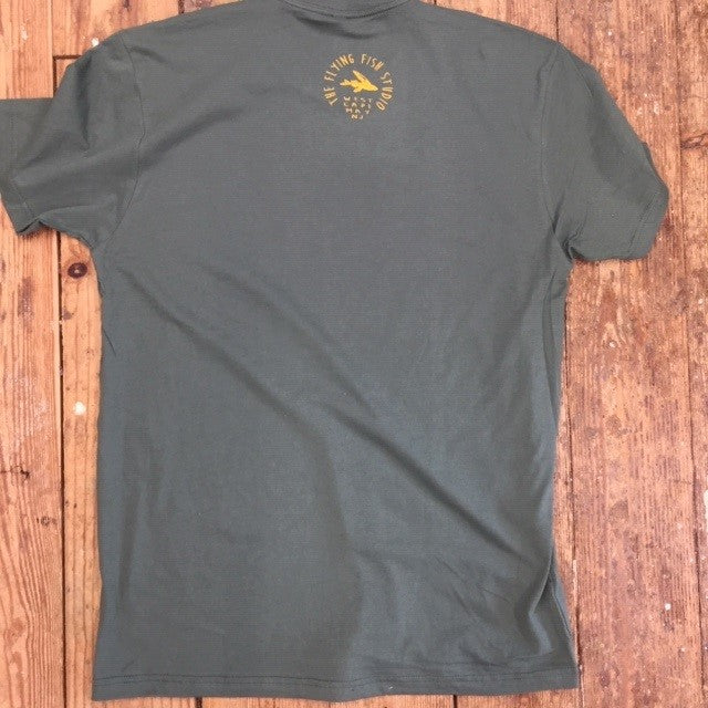 A green t-shirt featuring the 'Flying Fish Studio' logo on the back neck in gold ink.
