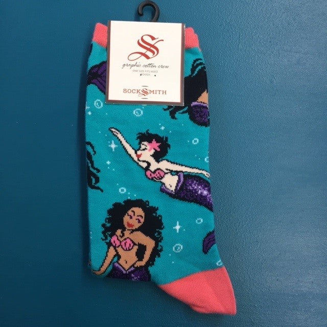 A teal pair of socks with mermaids on them.