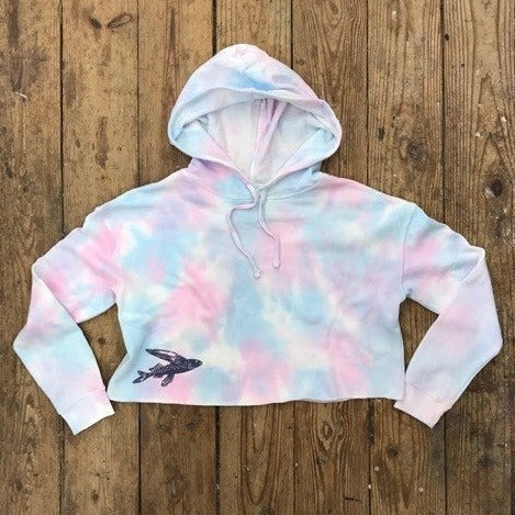 Pink & Blue tie-dyed cropped, pullover hoodie with a 'Flying Fish' design on the bottom, right front in dark purple.
